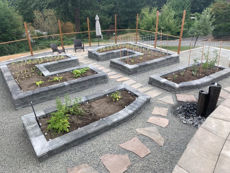 Our garden design services offer beautifully landscaped raised beds, complete with a cozy fire pit.